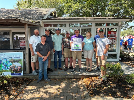 Secretary Naig and partners present the Longinaker family with the Good Farm Neighbor Award at the Iowa State Fair