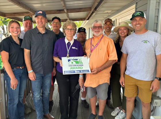Secretary Naig and partners presenting the Good Farm Neighbor Award to the Barnes Family at the Iowa State Fair