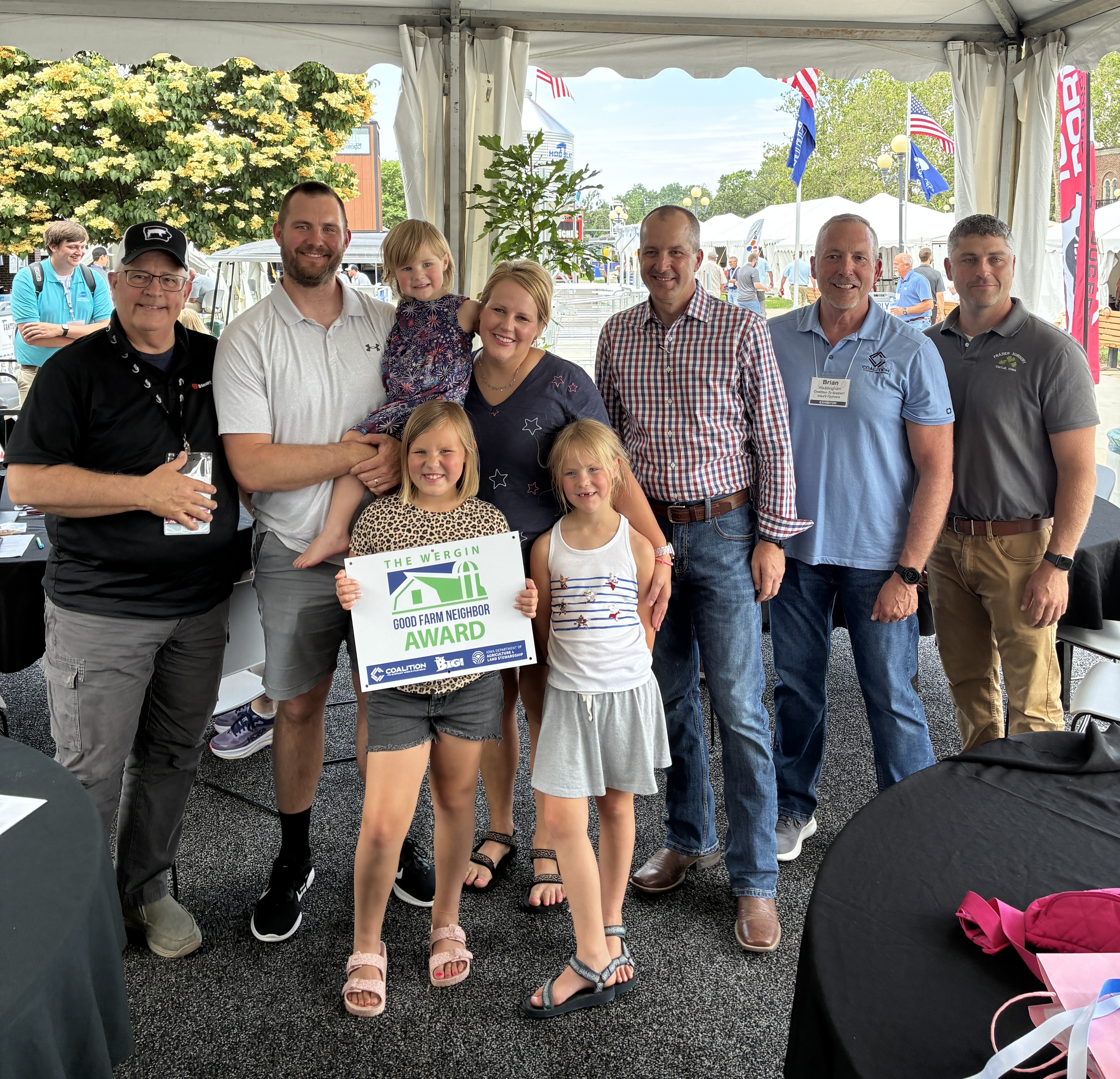owa Secretary of Agriculture Mike Naig presented the Nieuwendorp Family from Lyon County with the Wergin Good Farm Neighbor Award at the 2026 World Pork Expo in Des Moines. Pictured from left to right: Bob Quinn, Host of WHO The Big Show, Nathan and Jacklyn Nieuwendorp and their three daughters, Secretary Naig, Brian Waddingham, Executive Director of the Coalition to Support Iowa Farmers, and Alex Frazier of Frazier Nursery. 